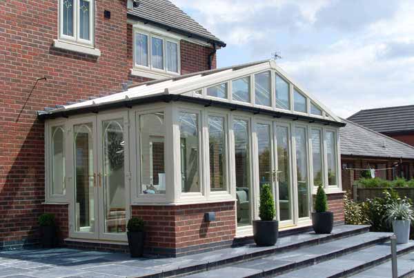 White conservatory with a sturdy brick exterior